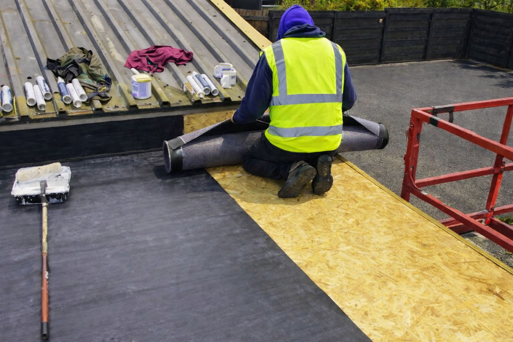 roofer installing EPDM garage roof